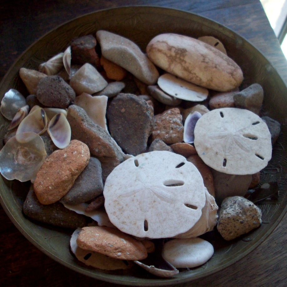 A small brass bowl filled with tiny treasures collected from Dauphin Island; shells, stones and pottery bits. All wash up on the bat side of the island.